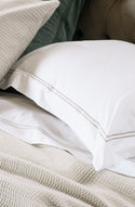 livorno white sheets with taupe stitching